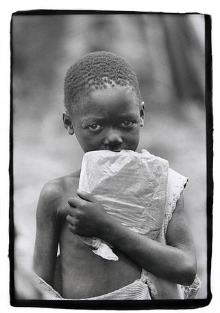 Boy with precious school books, Southern Sudan